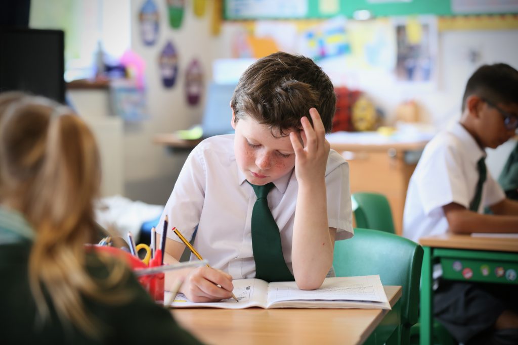 Prep School pupil working at a desk