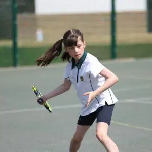 Prep pupil playing tennis