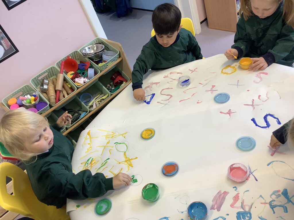 Early Years pupil painting