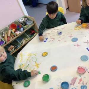 Early Years pupil painting