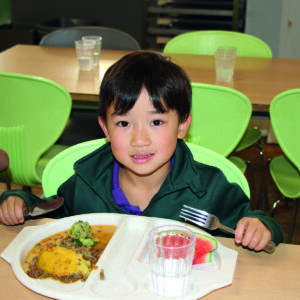 Prep School pupil eating lunch