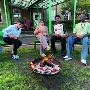 Boarding students toasting marshmallows