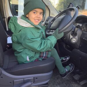 Early Years pupil in the mini bus