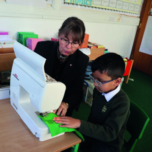 Year 2 pupil sewing