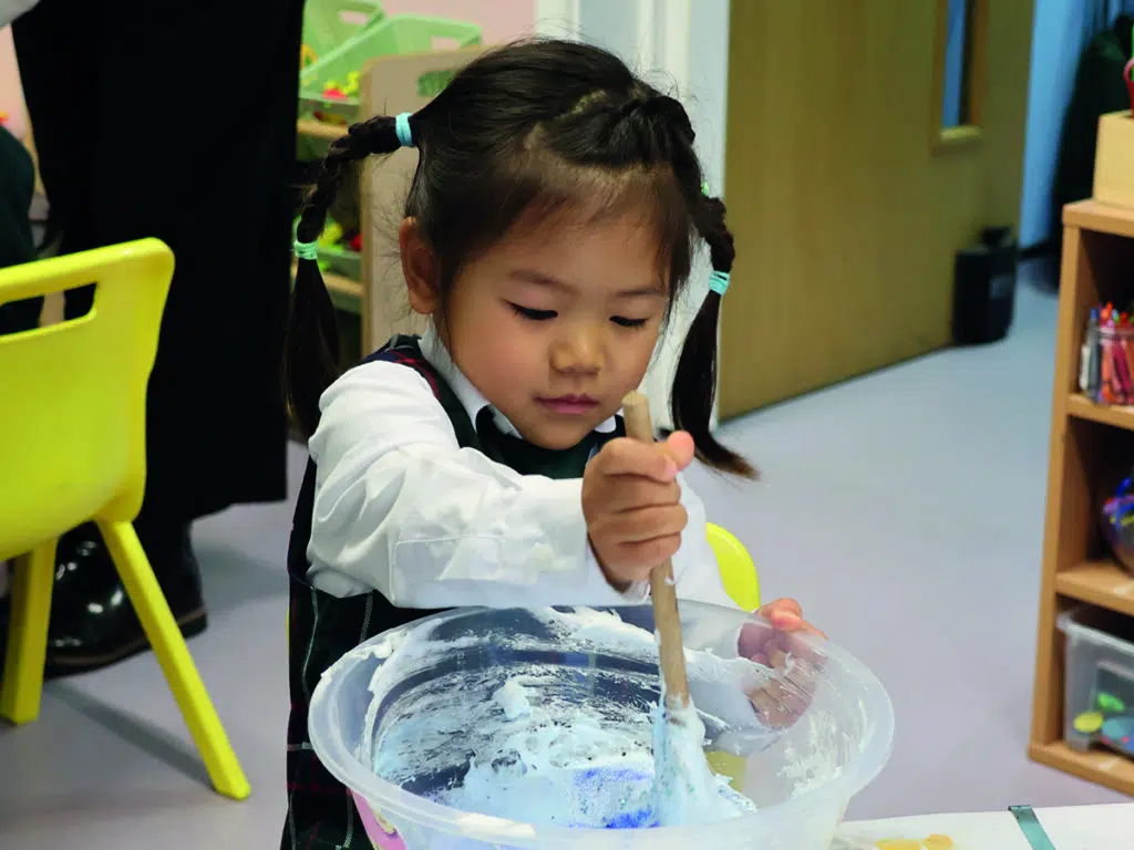 Early Years pupil making slime