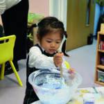 Early Years pupil making slime