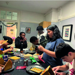 Boarding students decorating gingerbread houses