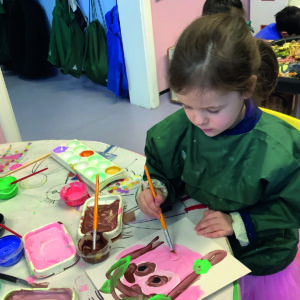 Early Years pupil painting