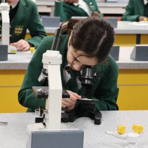 Prep School pupil looking through a microscope