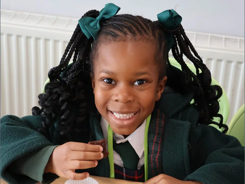 Prep School pupil eating vegetables