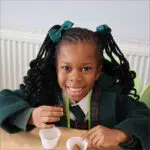 Prep School pupil eating vegetables