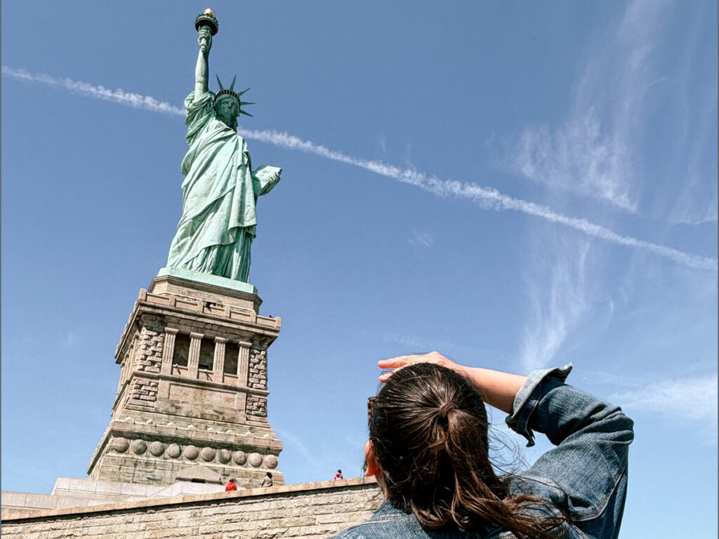 Sixth Form trip to New York, by the Statue of Liberty