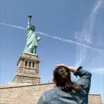 Sixth Form trip to New York, by the Statue of Liberty