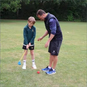 Year 4 pupil with a teacher having a golf lesson