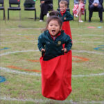 Pre-Reception pupil in the sack race