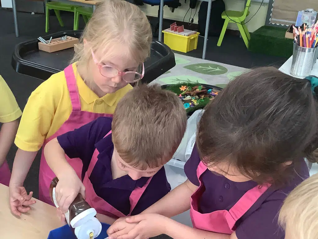 Early Years pupils baking a cake