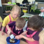 Early Years pupils baking a cake