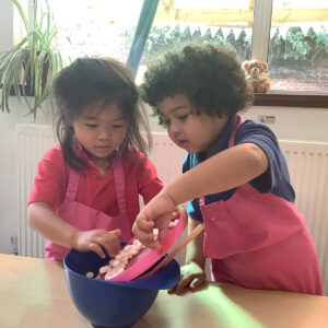 Early Years pupils baking a cake